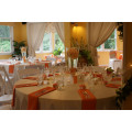White oval table cloths, orange napkins