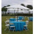 Light blue tablecloths with umbrella hole and white umbrella.