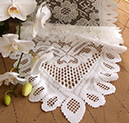 Lace table runner in white with orchids